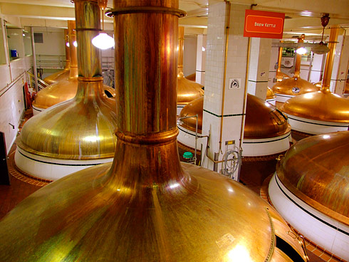 Dozens Massive golden-brass brew kettles
