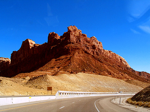 Red sandstone formation above highway