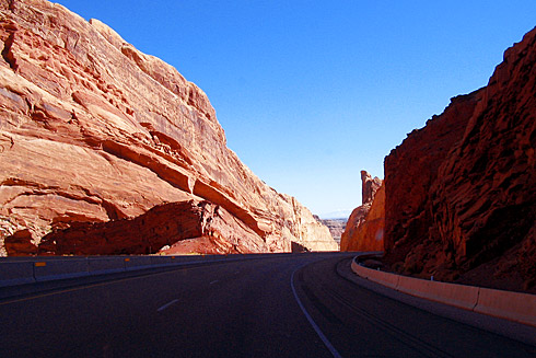 Red sandstone formation beside highway