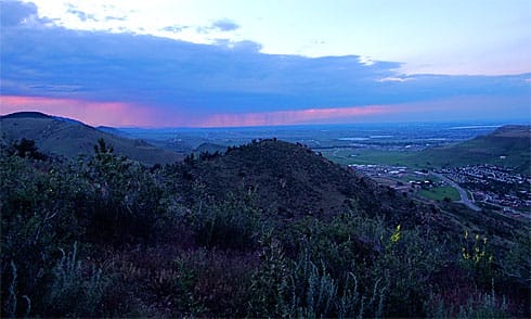 Distant clouds raining before the purple sunset light Distant clouds raining before the purple sunset light
