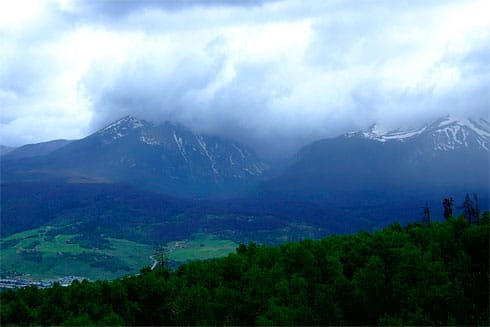 Huge clouds passing over mountain peaks Huge clouds passing over mountain peaks of the Rockies