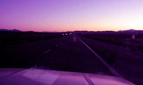 Orange dawnlight behind desert hills Orange dawnlight behind desert hills