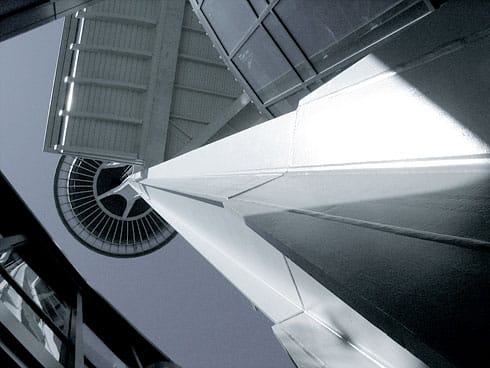 Space Needle support beams tower above (black and white)