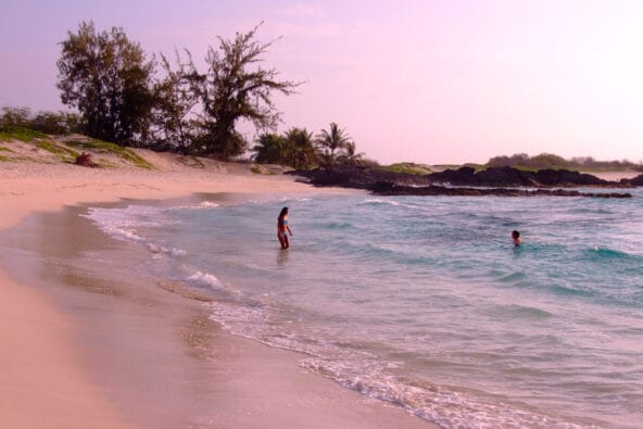 A couple frolicking on Makalawena Beach