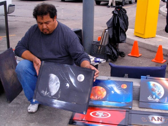 Artist holding up golden gate n star field painting