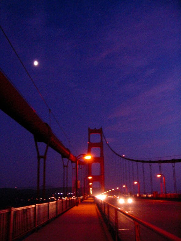Bright moon above Golden Gate Bridge at dusk