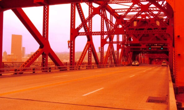 Broadway Bridge forms reddish tunnel over Willamette River