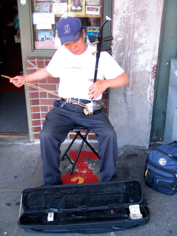 Chinese man playing strange instrument