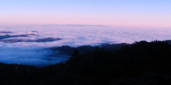 Clouds rolling over hills n Pacific Ocean