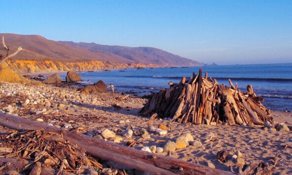Crude wooden hut before Big Sur coastline