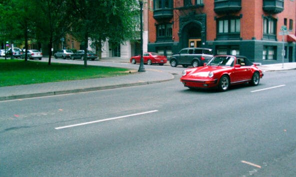 Cute red convertible driving around Portland Park Blocks