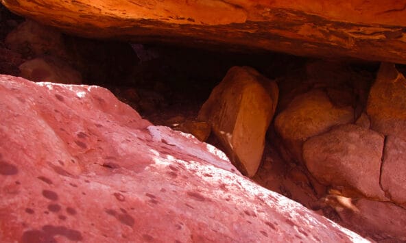 Dark Crevice between Red Boulders