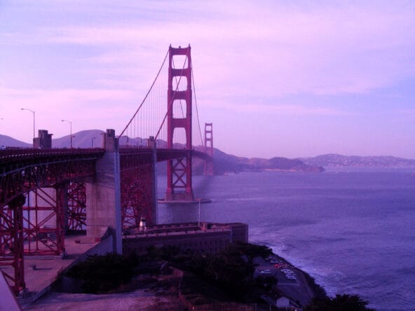 Golden Gate bridge spanning bay Fort Point Light below