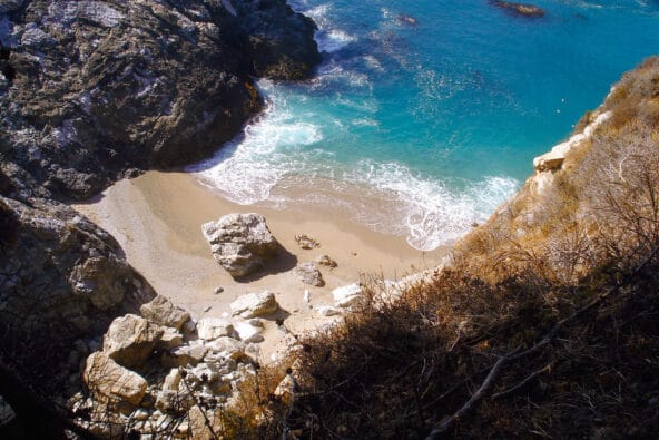 Gray boulders on tiny beach