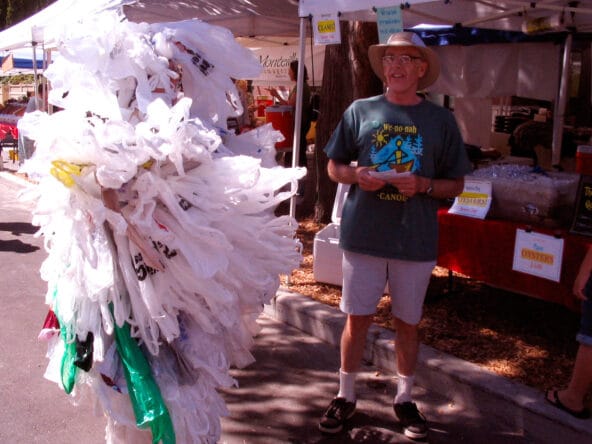 Man promoting green bags with Plastic Bag Monster