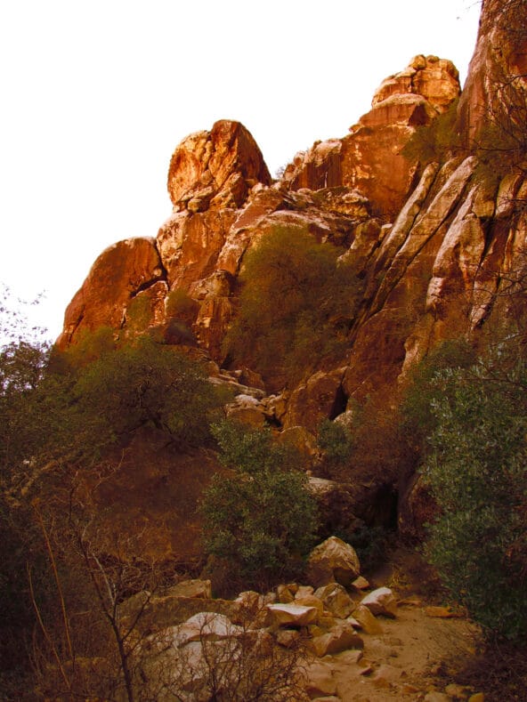Orange light hitting towering boulders