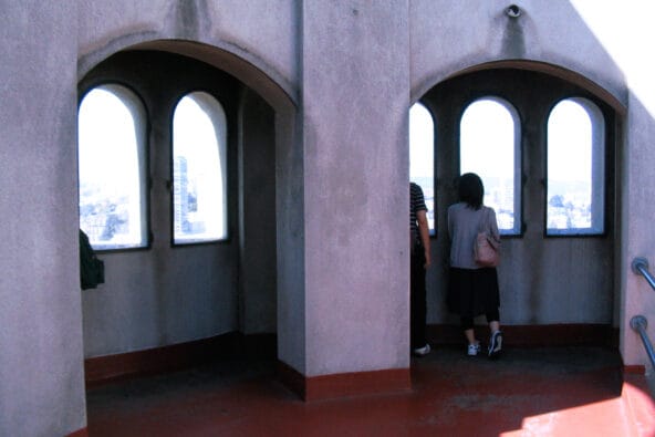 People looking out Coit Tower windows