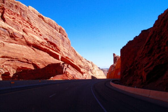 Red sandstone formation beside highway