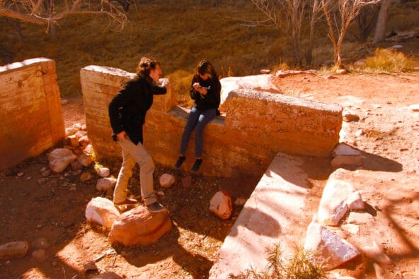 Robin n DT sitting on stone house ruins