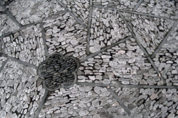 Small stones in angular floor tiles (closeup)
