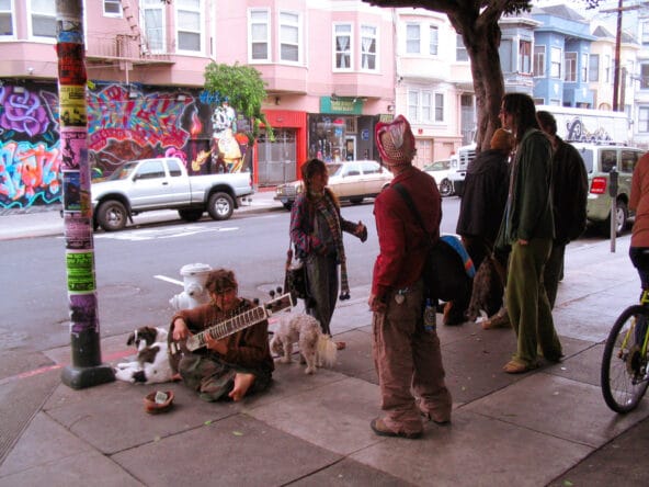 Street performer with sitar and hippies