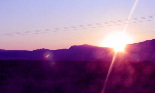 Sunrise behind desert hills