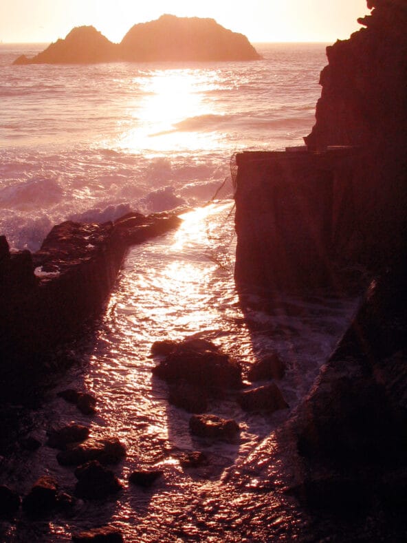 Sunset reflecting off wet stone path zoom