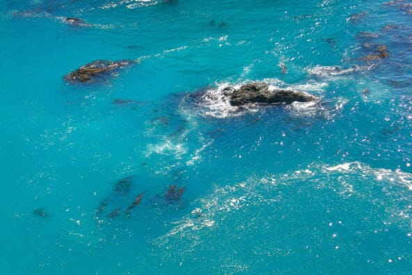 Water swirling in a bluegreen bay (zoom)