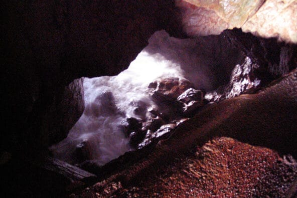 Waves crashing on small tunnel under path