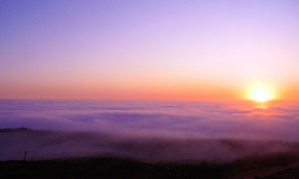 Yellow Pink Sunset over ocean clouds