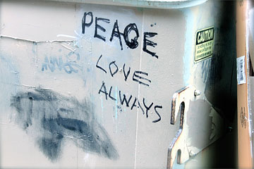 PEACE LOVE ALWAYS written in Graffiti on a dumpster
