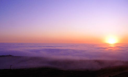 Yellow-Pink Sunset over ocean clouds